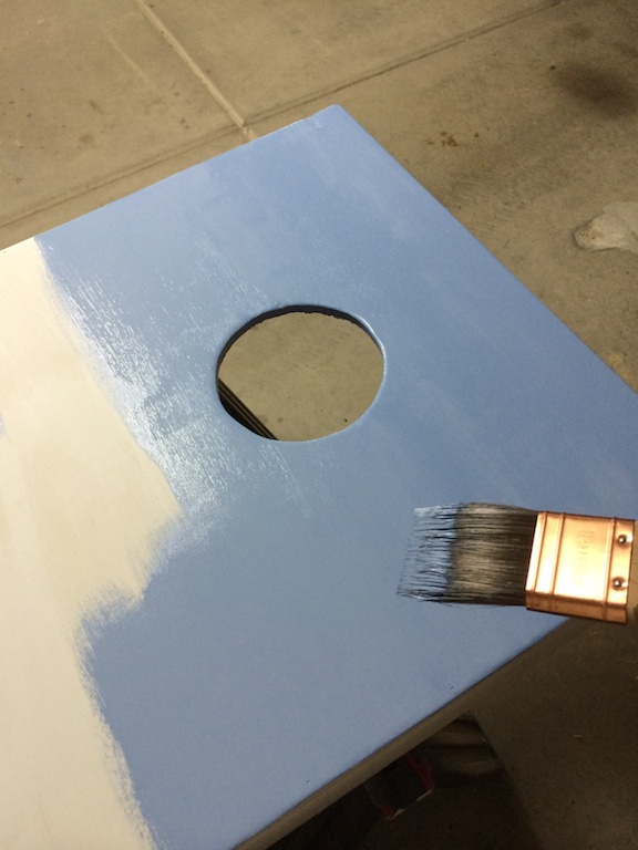 Cornhole board primed and getting paint