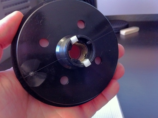 White tabs in center of button hold top in place