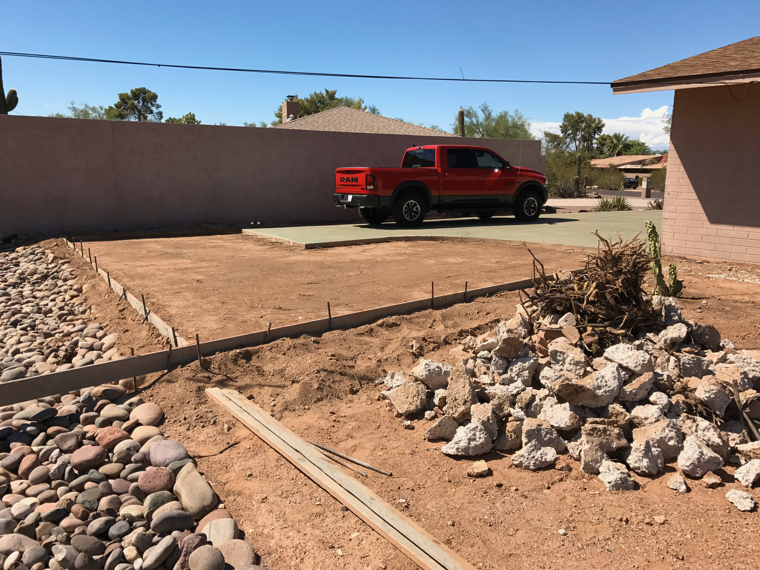 Old driveway is tinted green (been that way for decades) and new extension is framed up, ready for concrete pour