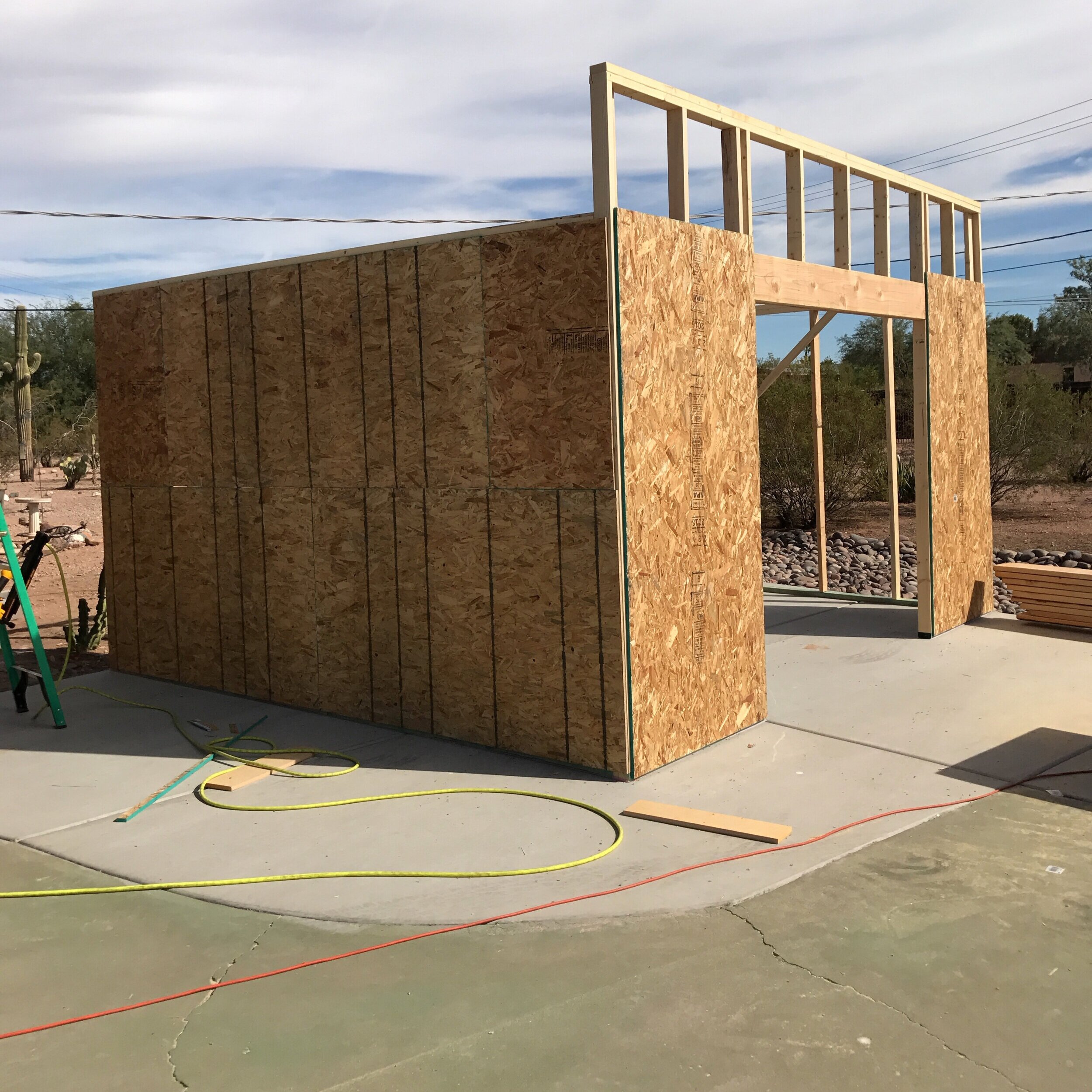 Some of the wall sheathing is up and notice the header over the door opening